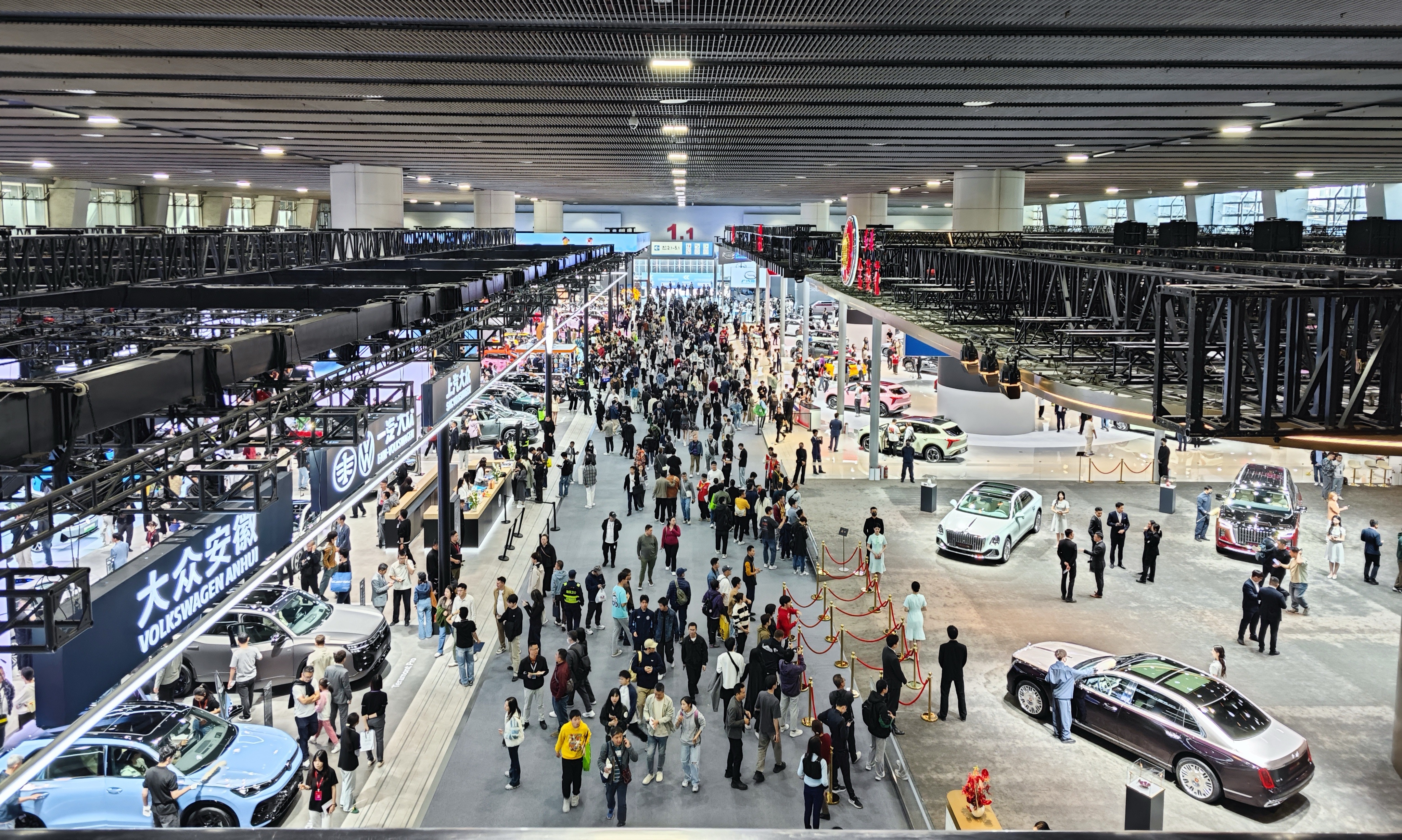 Guangzhou International Automobile Exhibition hall with vehicles and visitors